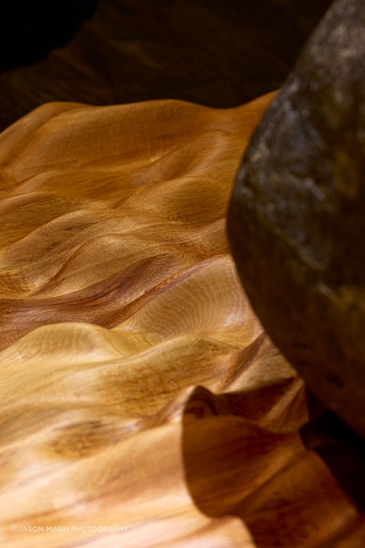 The undulating waves referencing the source river were carved into native rimu timber that sits beneath the mouri stone using a CNC machine.