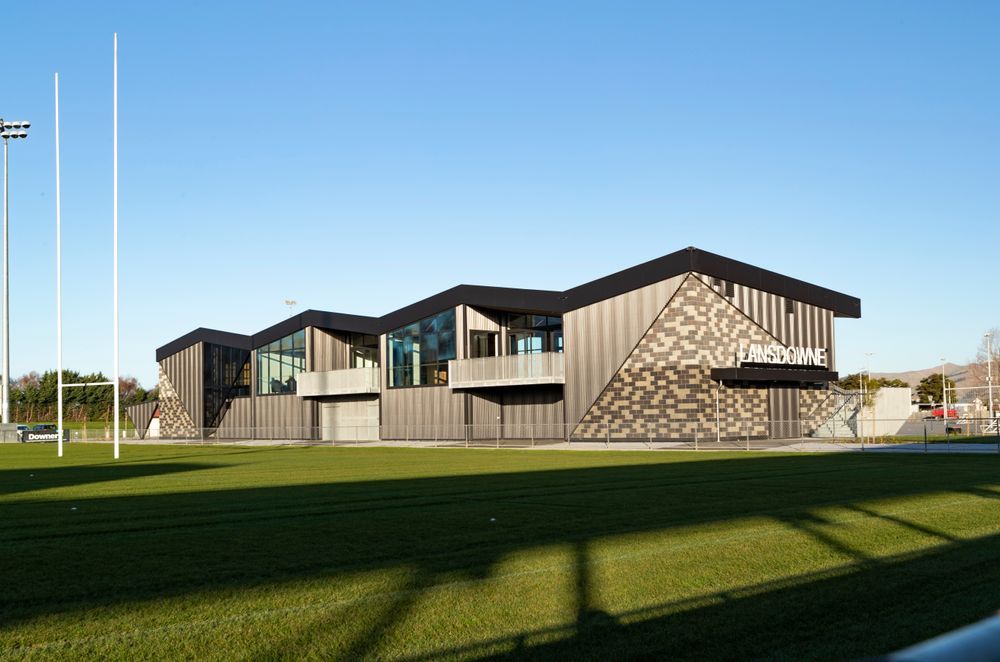 The combination of block walls juxtaposed against a light-weight corrugate structure, with a folded roof floating above gives the building a textural and geometric interest.