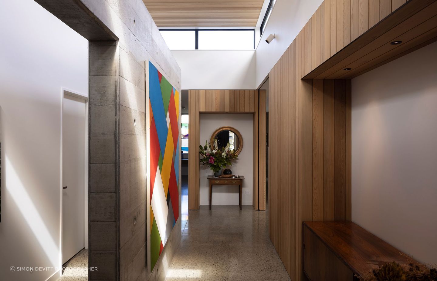 “The clerestory windows really unlock the centre of the house. The stud height is nearly four metres in here, and glazed all around. The concrete wall down the middle is a very strong pivot point between all parts of the house and becomes a gallery space.”