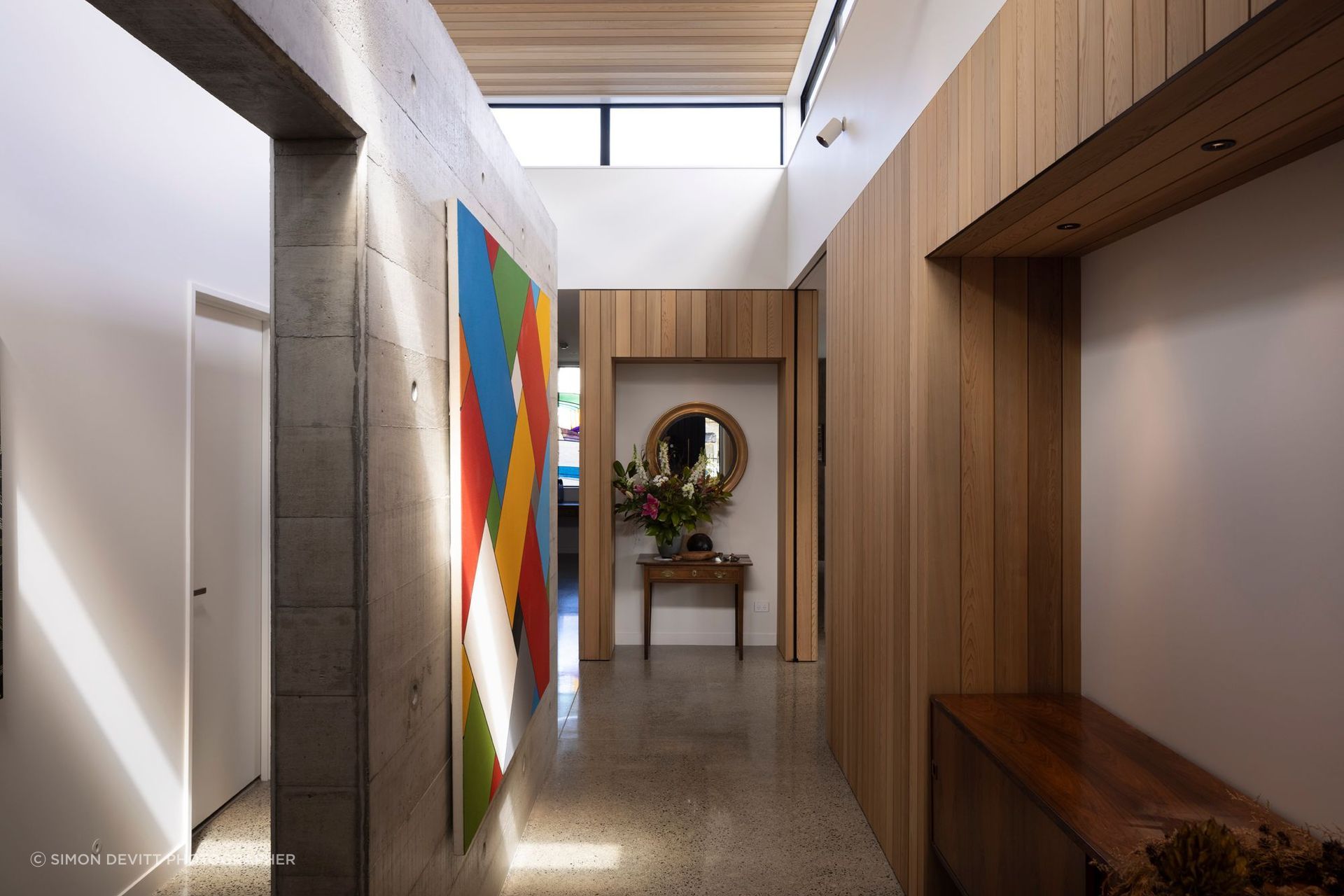 “The clerestory windows really unlock the centre of the house. The stud height is nearly four metres in here, and glazed all around. The concrete wall down the middle is a very strong pivot point between all parts of the house and becomes a gallery space.”