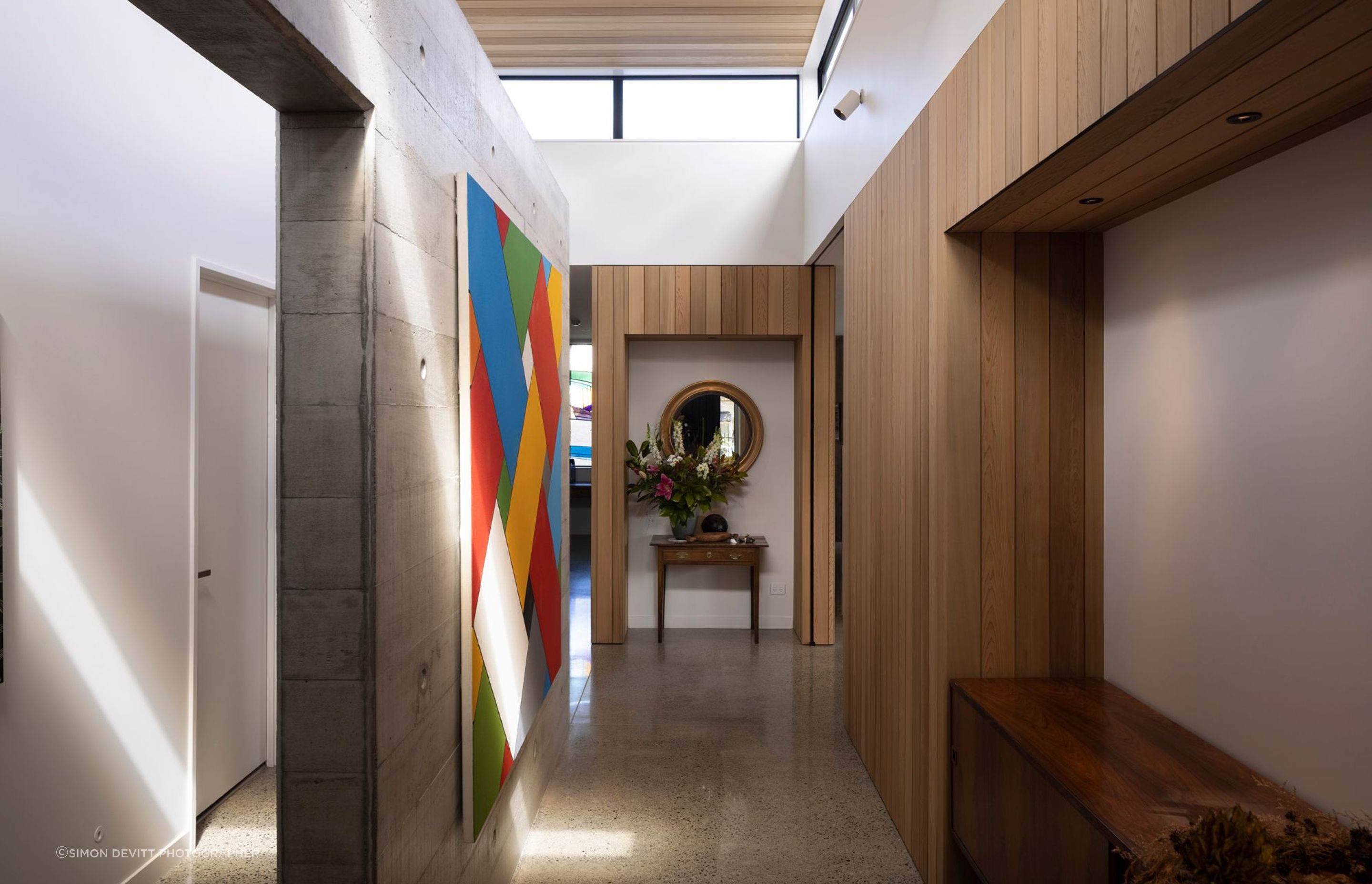 “The clerestory windows really unlock the centre of the house. The stud height is nearly four metres in here, and glazed all around. The concrete wall down the middle is a very strong pivot point between all parts of the house and becomes a gallery space.”
