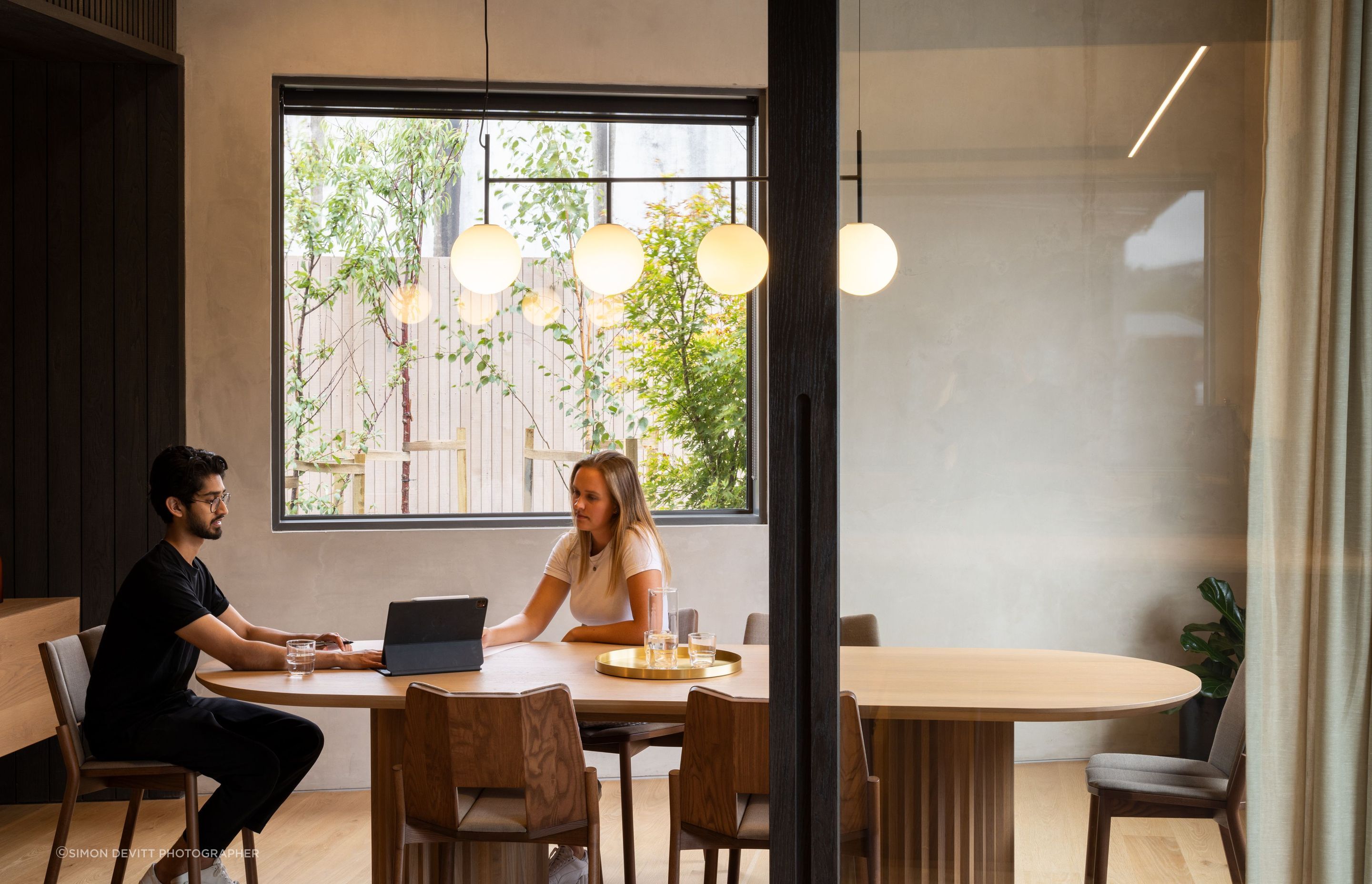 The interior wall is an exposed tilt panel concrete panel that has been rendered. The Menu suspension light is from Simon James.