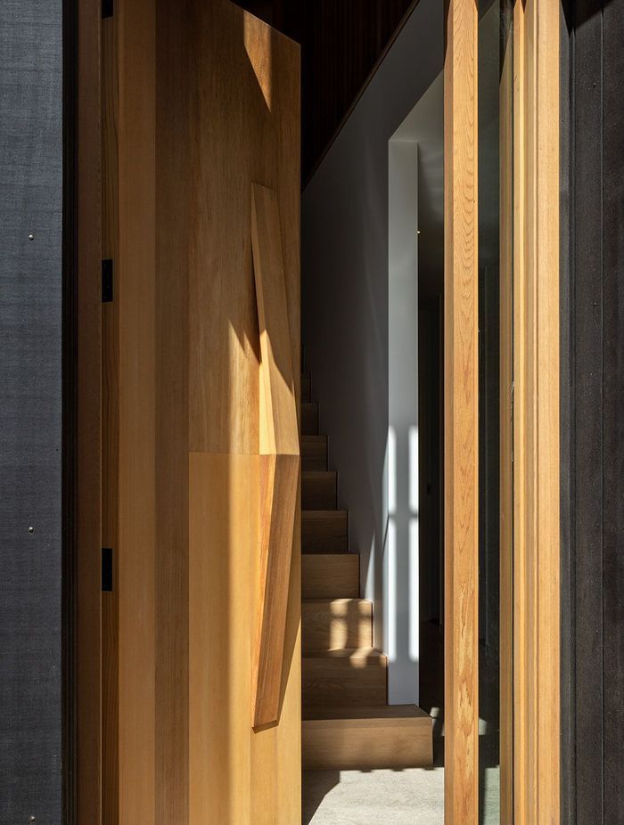 The door opens onto a timber staircase.