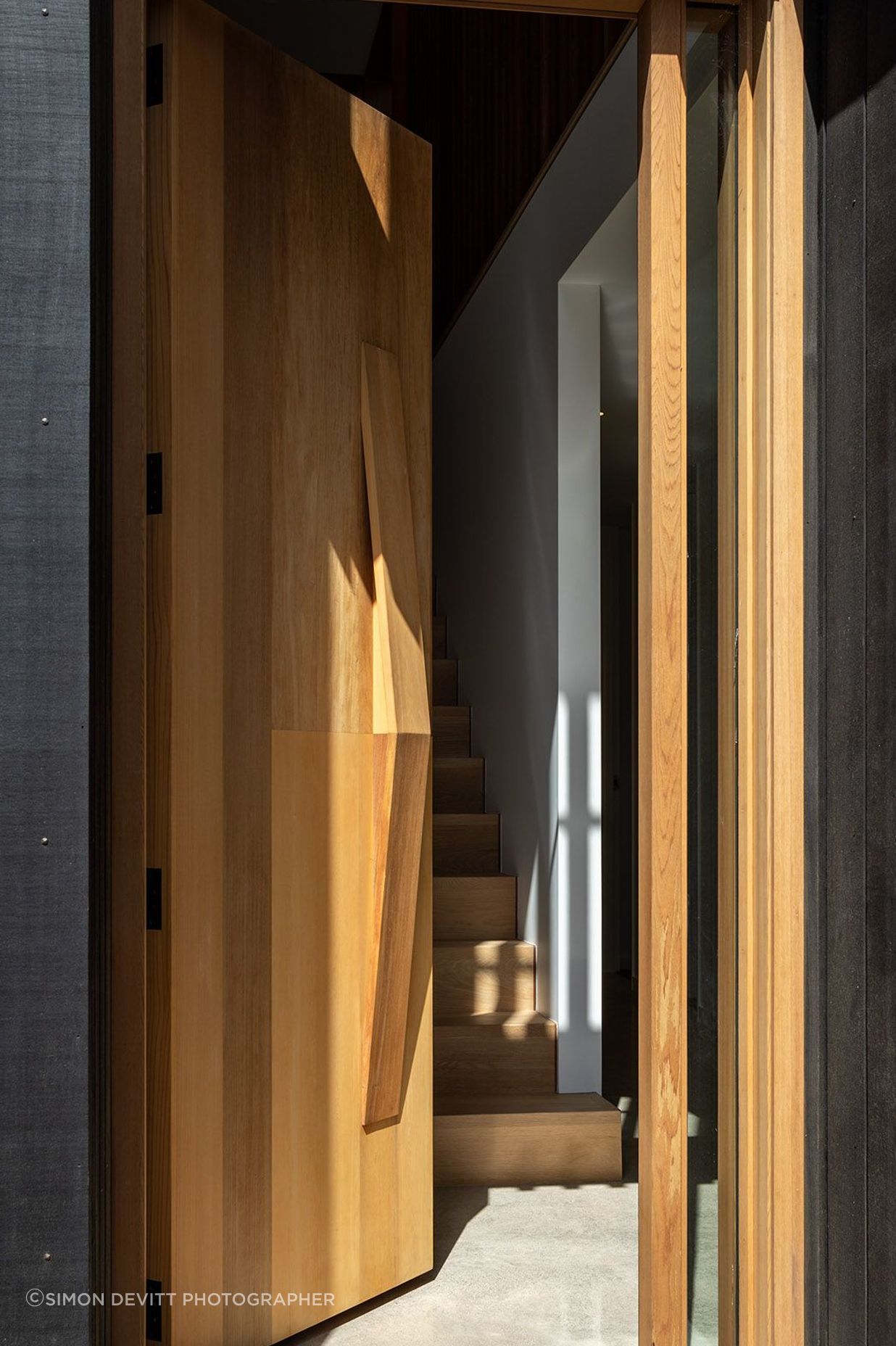 The door opens onto a timber staircase.