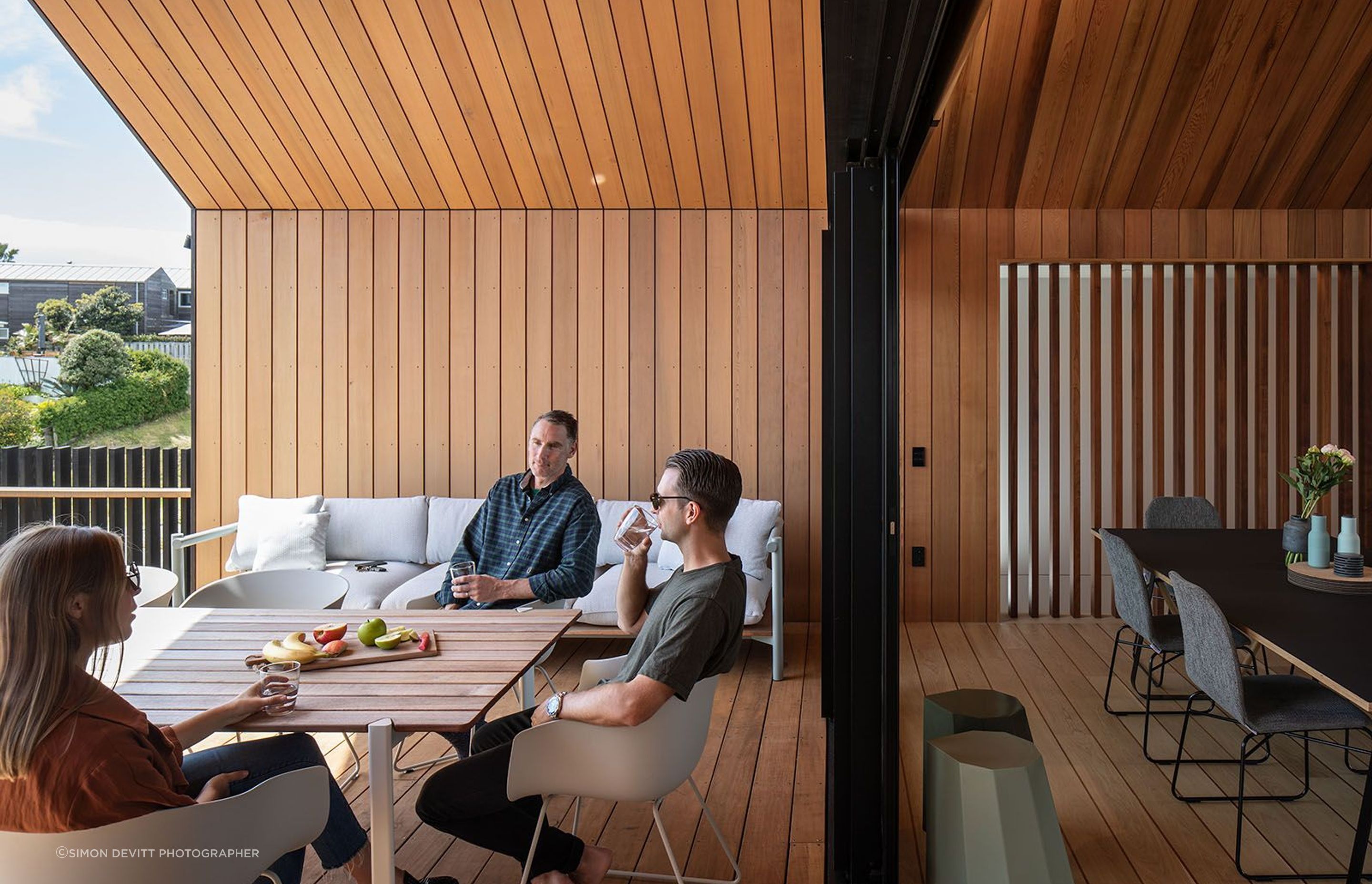 Sliding doors connect the kitchen and living areas to the east-facing covered courtyard.