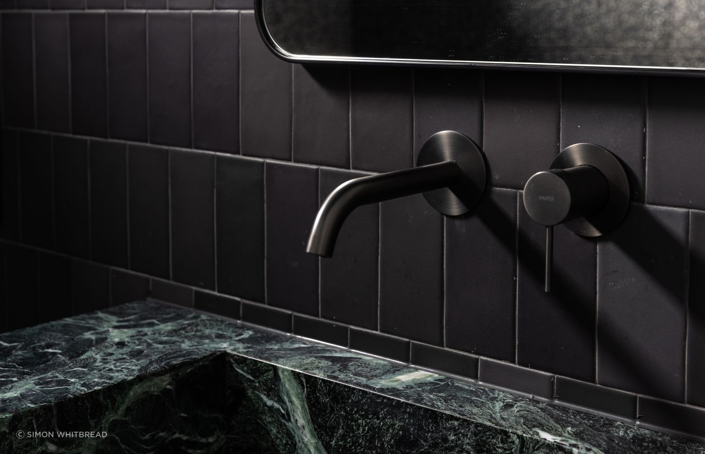 The power room is dark and moody, making a statement in a small space.