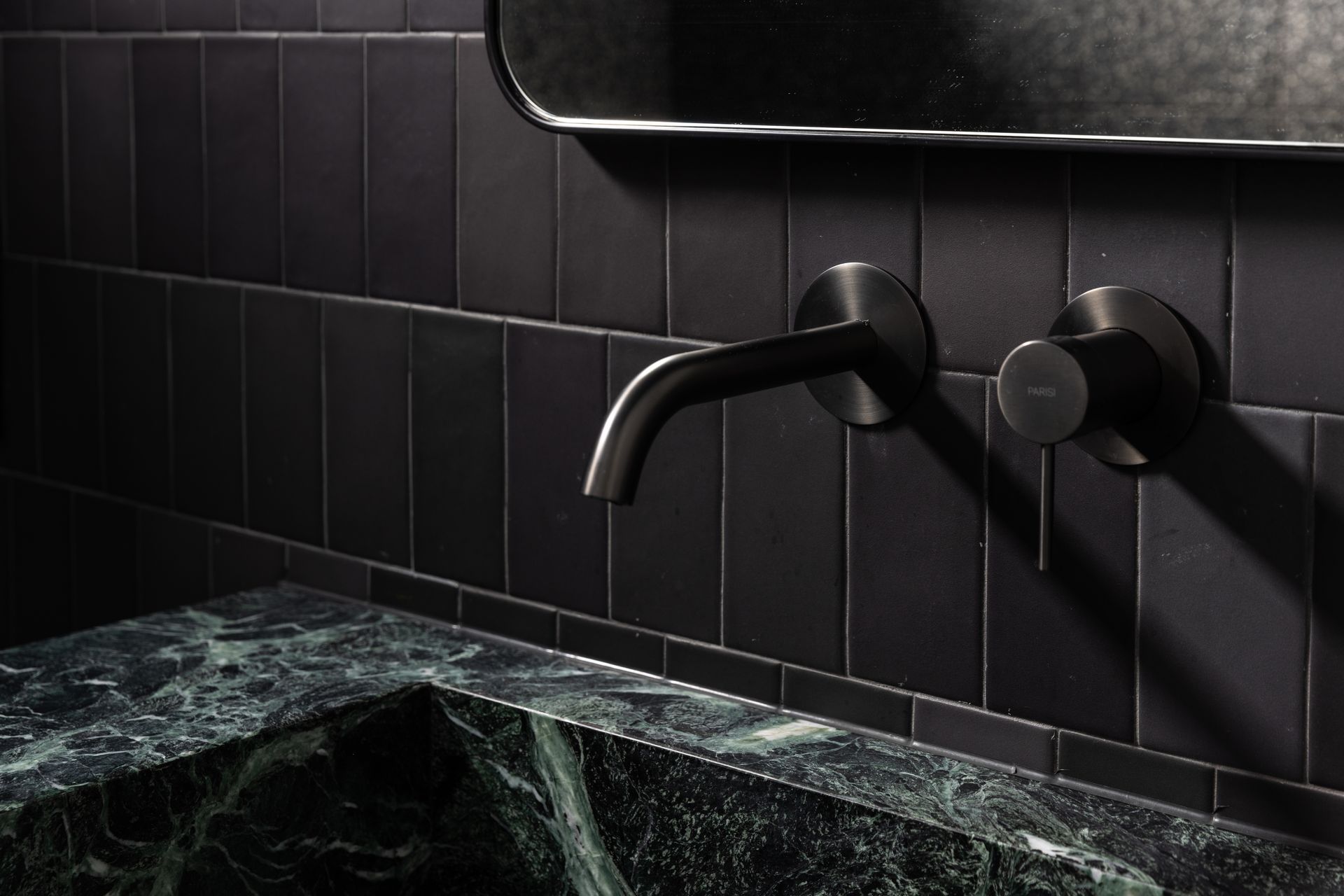 The power room is dark and moody, making a statement in a small space.