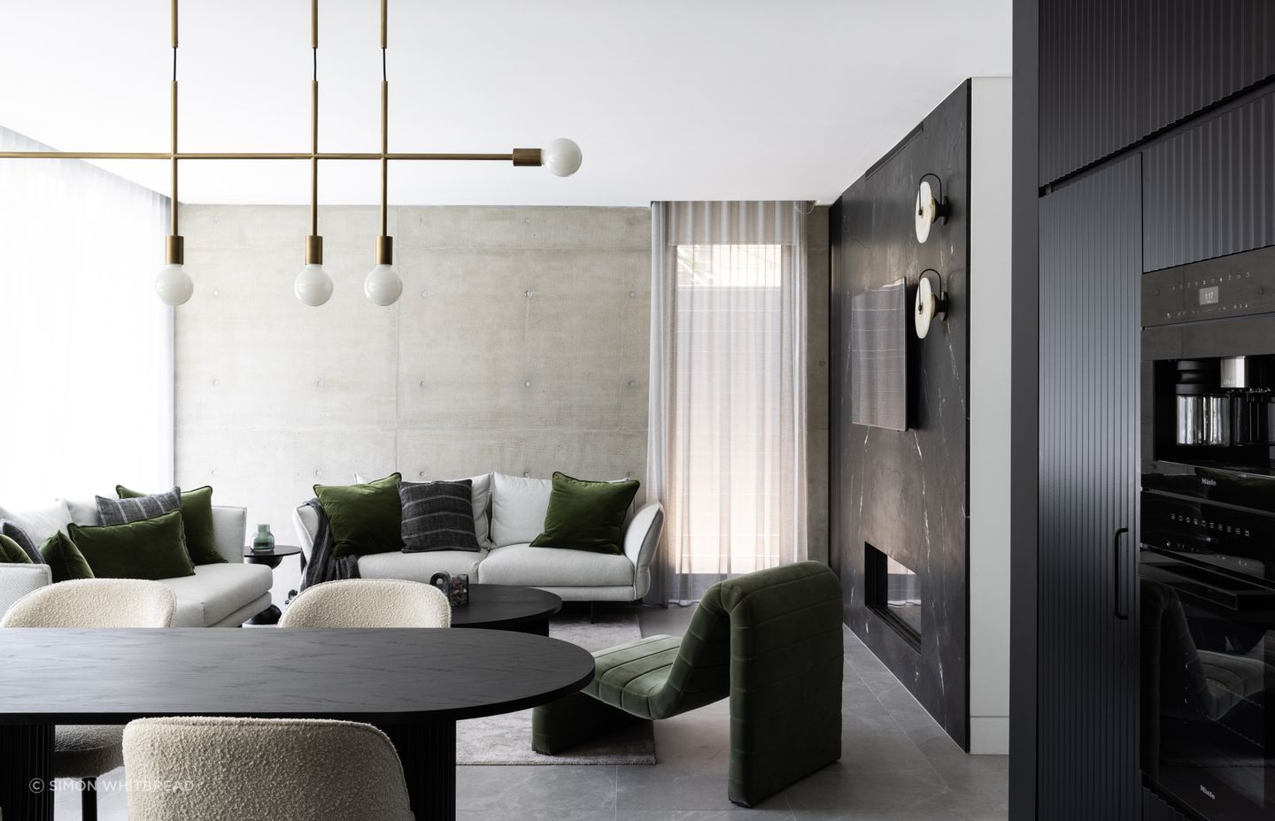 Pre-cast concrete panels are textural in the living area, helping the interior tie in with the home's exterior.