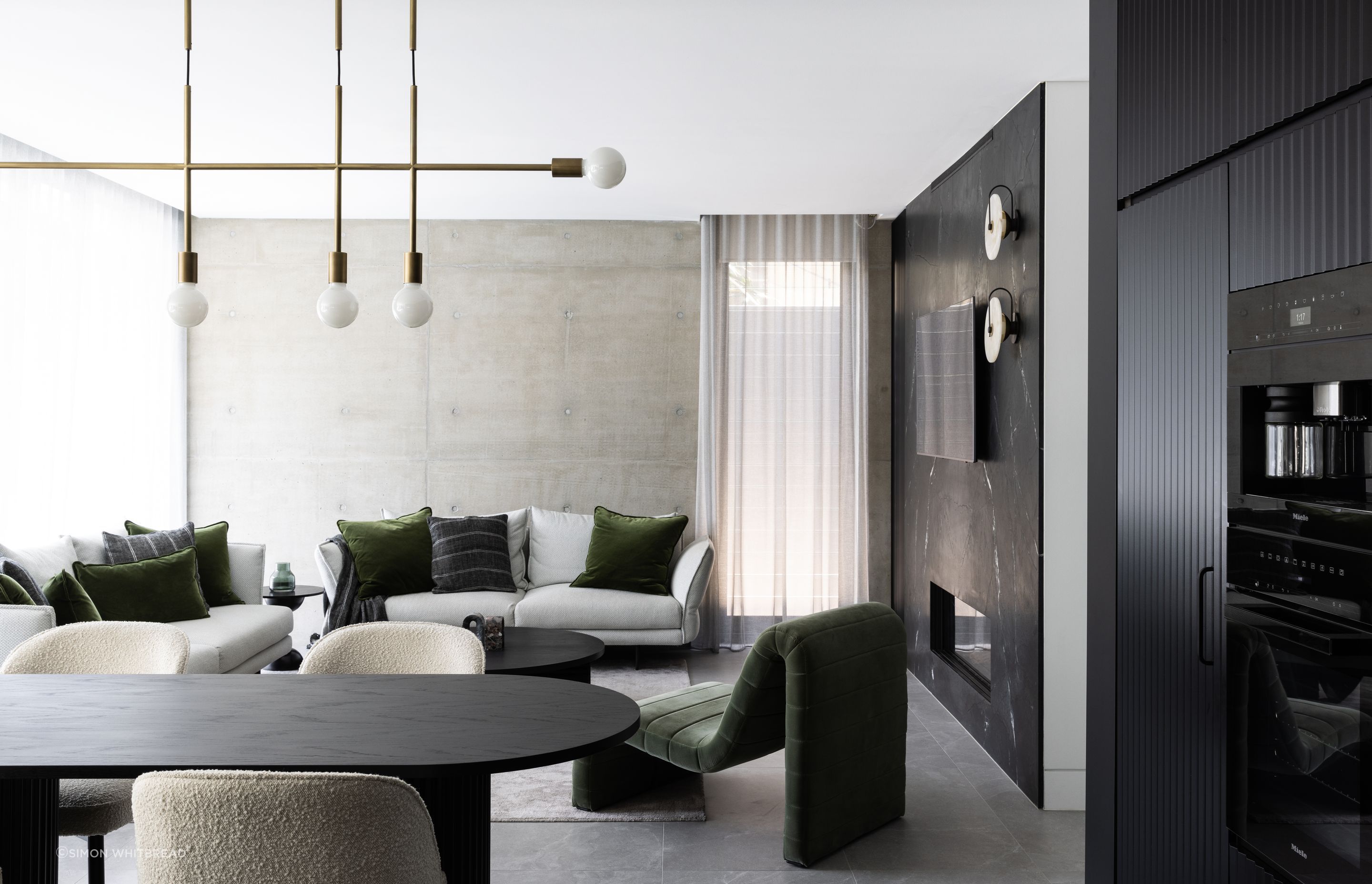 Pre-cast concrete panels are textural in the living area, helping the interior tie in with the home's exterior.