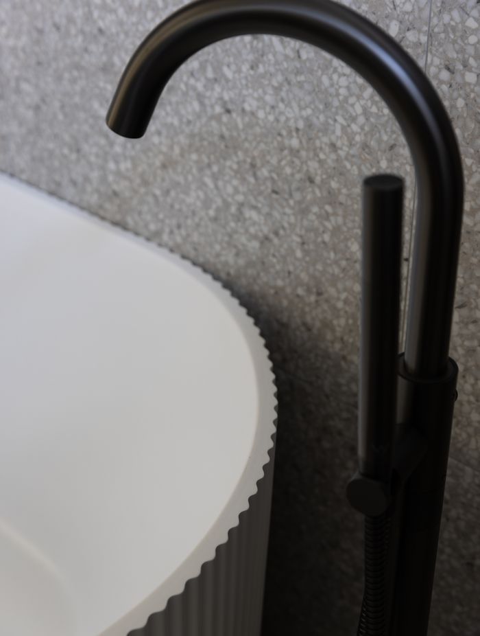 No attention to detail has been spared with the bathtub in the main bathroom a nod to the fluted pattern of the kitchen cabinetry.