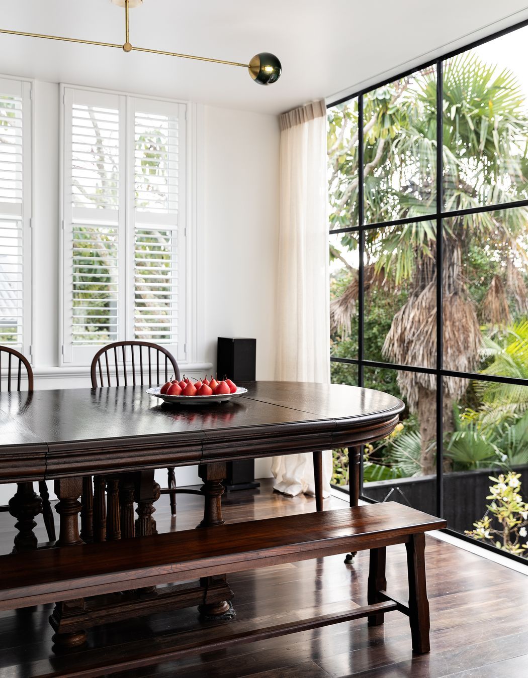 A French banquet table from John Stephens was the perfect fit for the dining room, which overlooks the brick salt water swimming pool.
