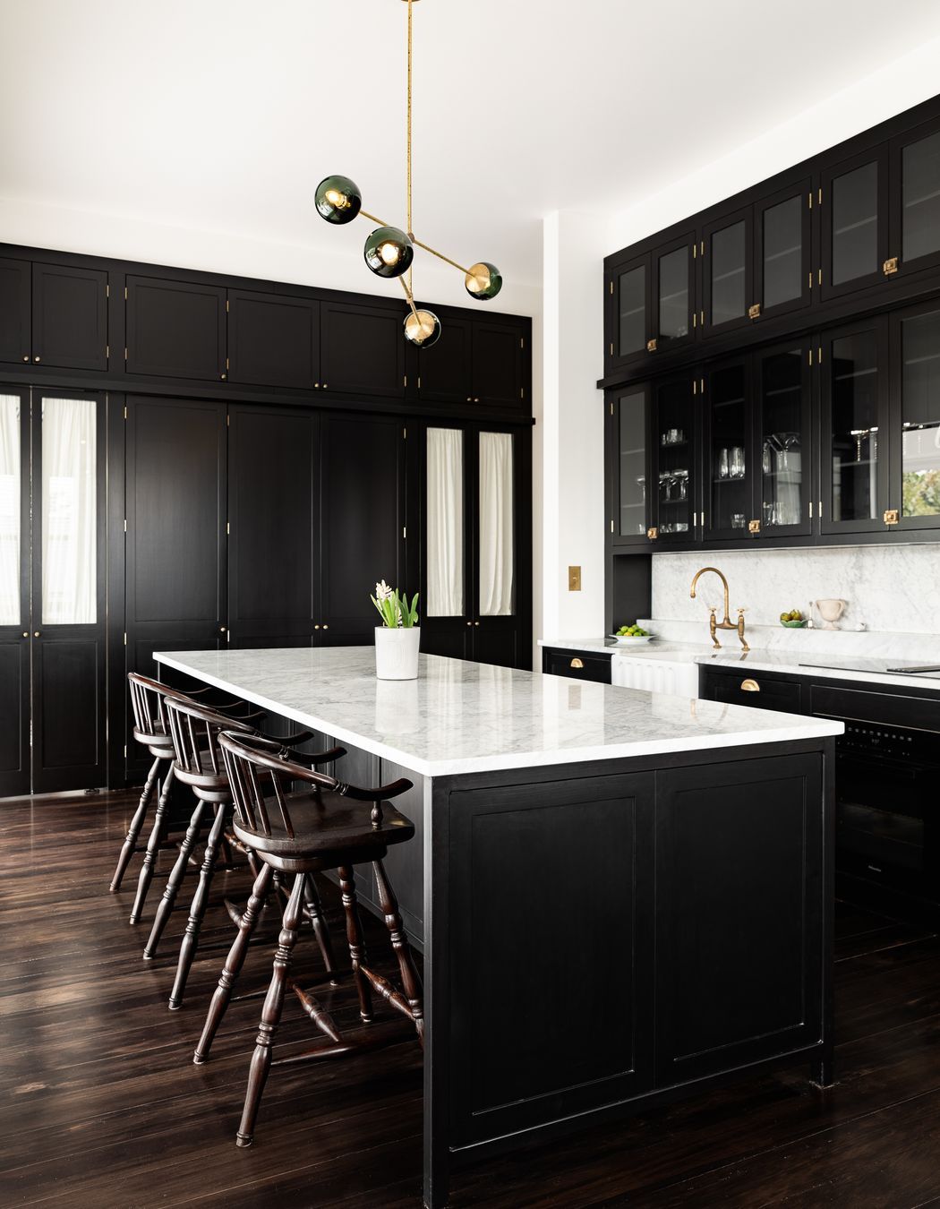 The kitchen design has been influenced by Victorian apothecaries and their use of display cabinetry that towered to the ceiling and was accessed via a ladder.