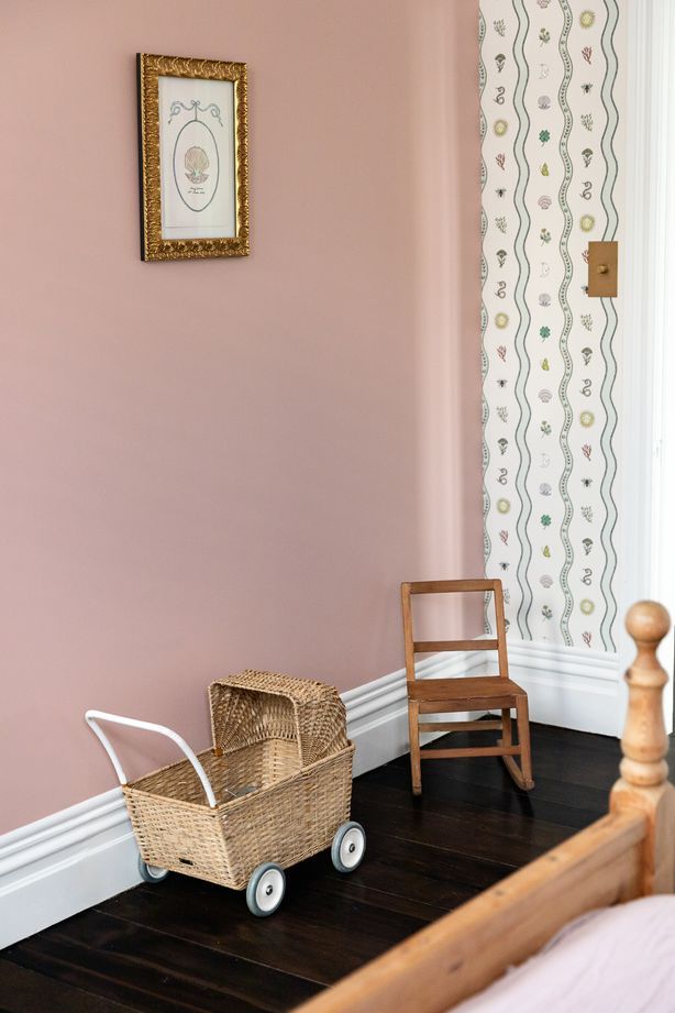 Special touches to Romy's room include artwork and wallpaper by Fee Greening. Brass bow wardrobe handles tie in with the other brass accents.