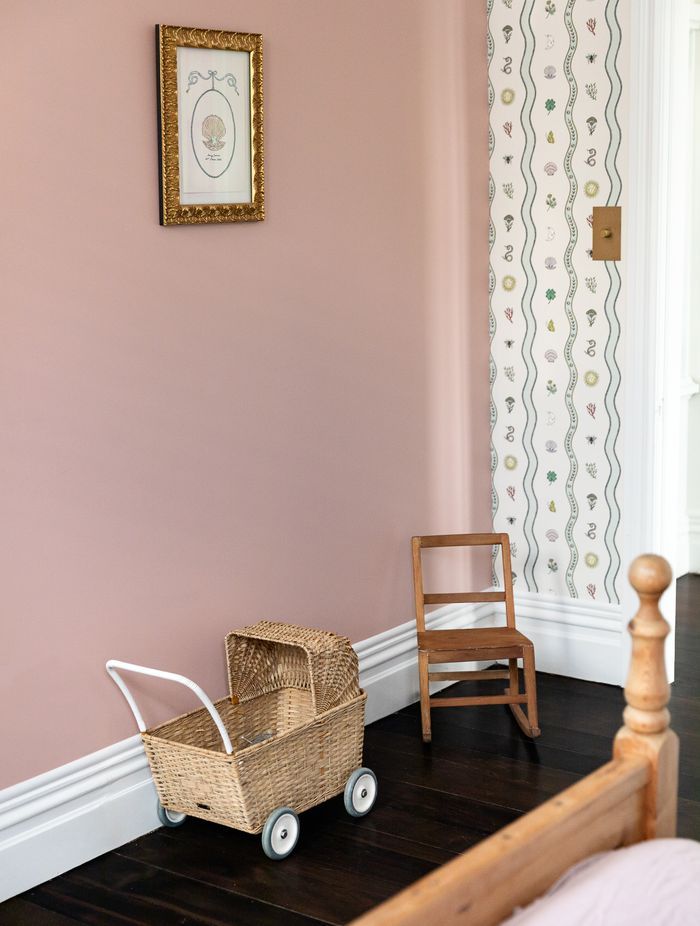Special touches to Romy's room include artwork and wallpaper by Fee Greening. Brass bow wardrobe handles tie in with the other brass accents.