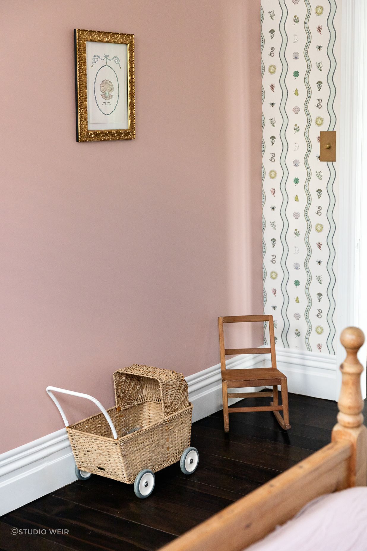 Special touches to Romy's room include artwork and wallpaper by Fee Greening. Brass bow wardrobe handles tie in with the other brass accents.