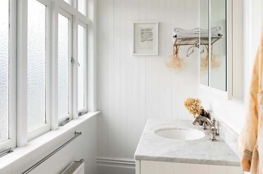 The renovated master ensuite is bright and airy with high ceilings, a marble counter and Perrin & Rowe tapware.