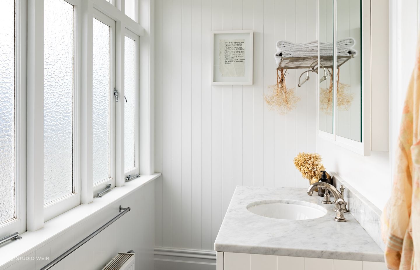 The renovated master ensuite is bright and airy with high ceilings, a marble counter and Perrin &amp; Rowe tapware.