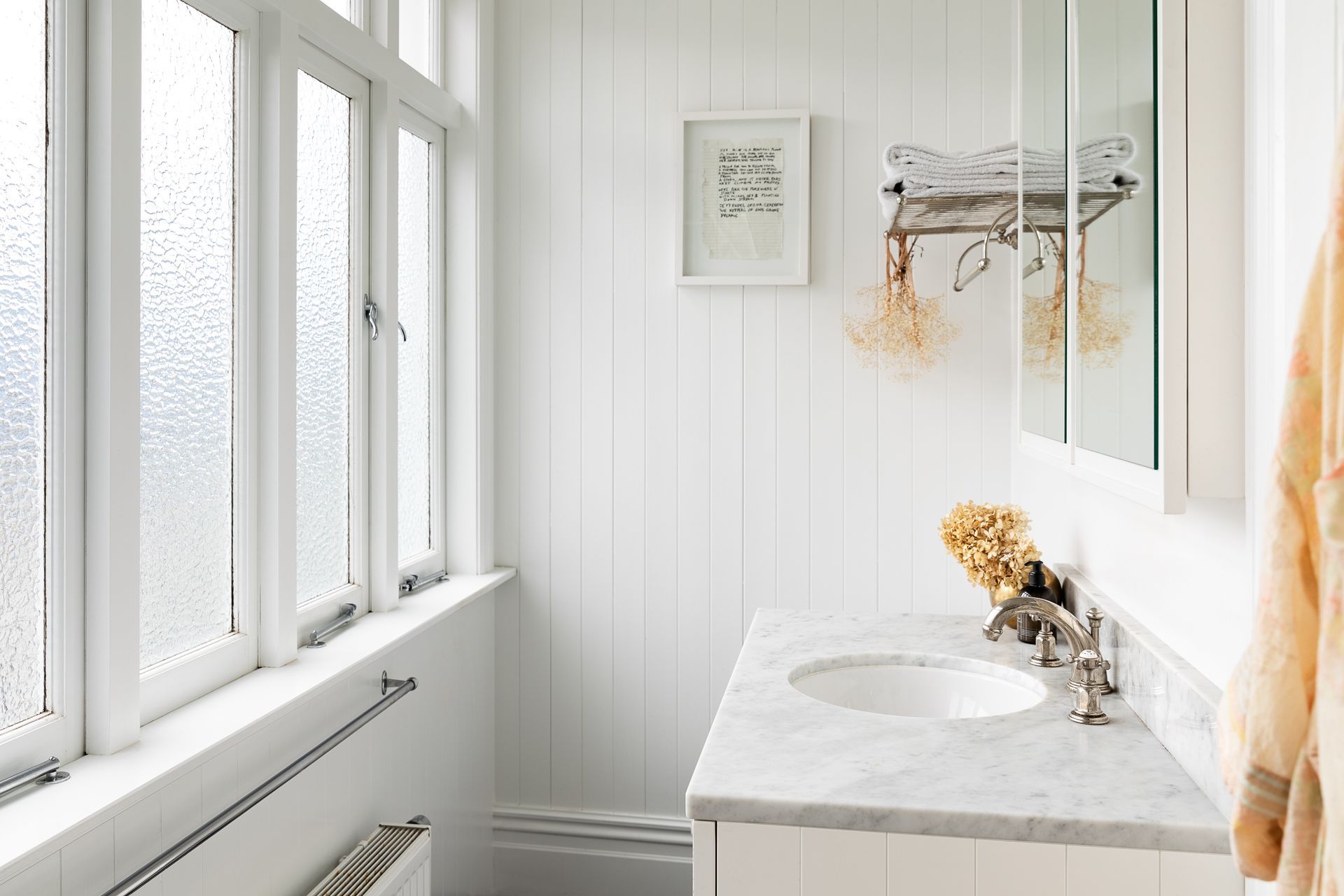 The renovated master ensuite is bright and airy with high ceilings, a marble counter and Perrin & Rowe tapware.