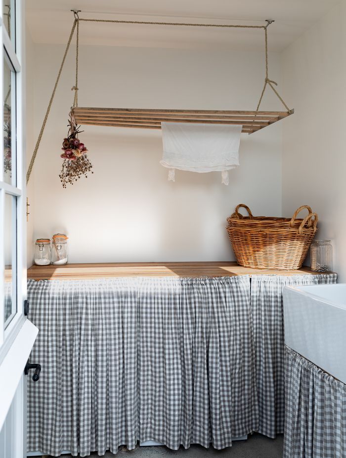 The laundry bench was made by German Kitchens out of old doors found under the house. The laundry skirt is by Island Interiors.