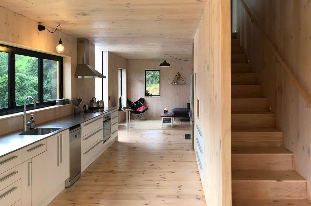 Practical features like the stainless steel benchtop and stairwell storage make this a stylish and functional space