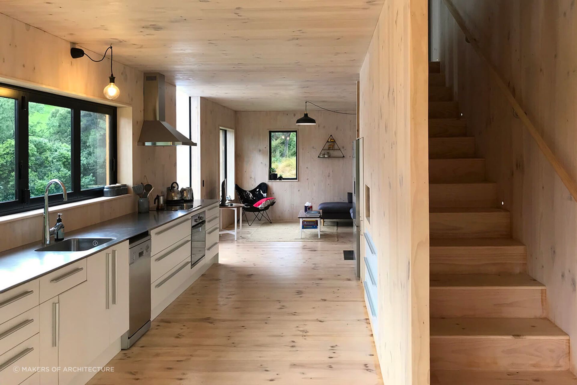 Practical features like the stainless steel benchtop and stairwell storage make this a stylish and functional space