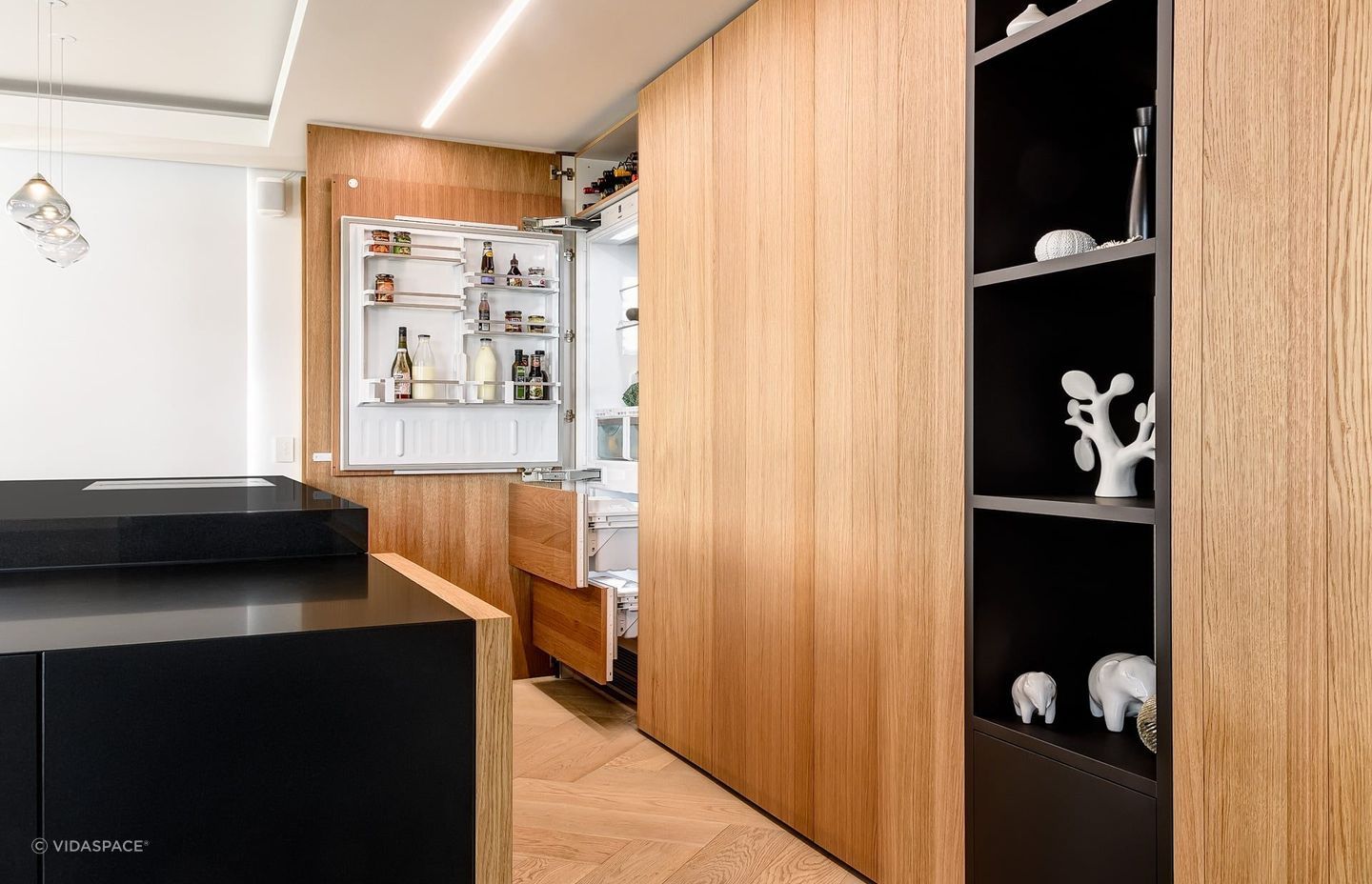 The Natural Allegro Brushed Querkus Unfinished Veneer helps create a clean, minimalist look, hiding appliances from view.