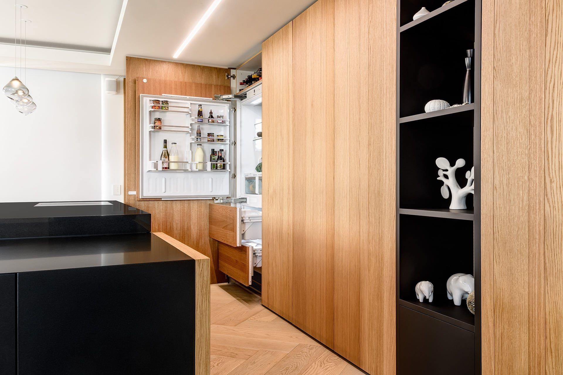 The Natural Allegro Brushed Querkus Unfinished Veneer helps create a clean, minimalist look, hiding appliances from view.