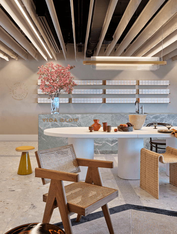 The lobby combines terrazo flooring with scupltural furniture and feminine colours to showcase the brand's identity.