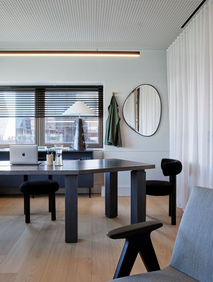The warm timber floors of the office space juxtapose beautifully against the dark, sculptural furniture.