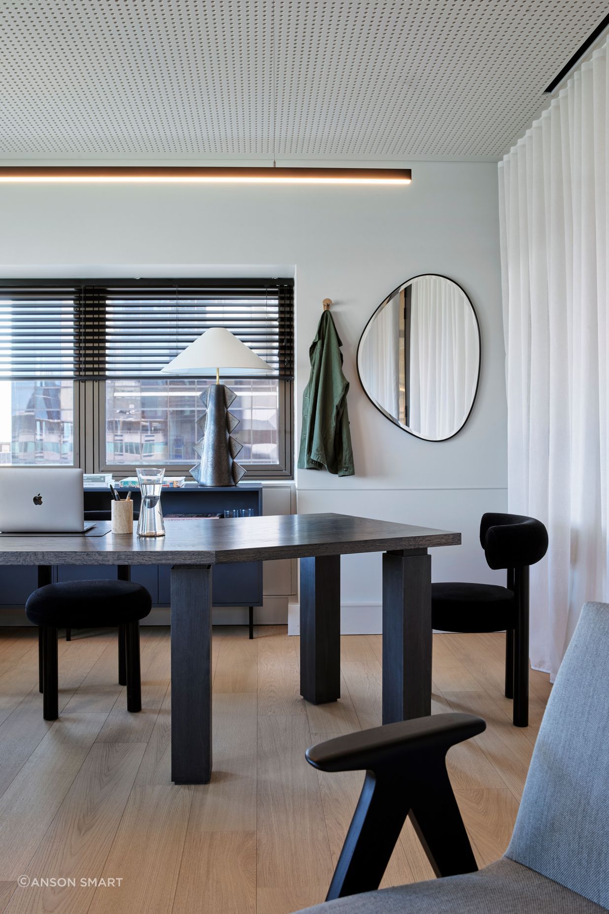 The warm timber floors of the office space juxtapose beautifully against the dark, sculptural furniture.