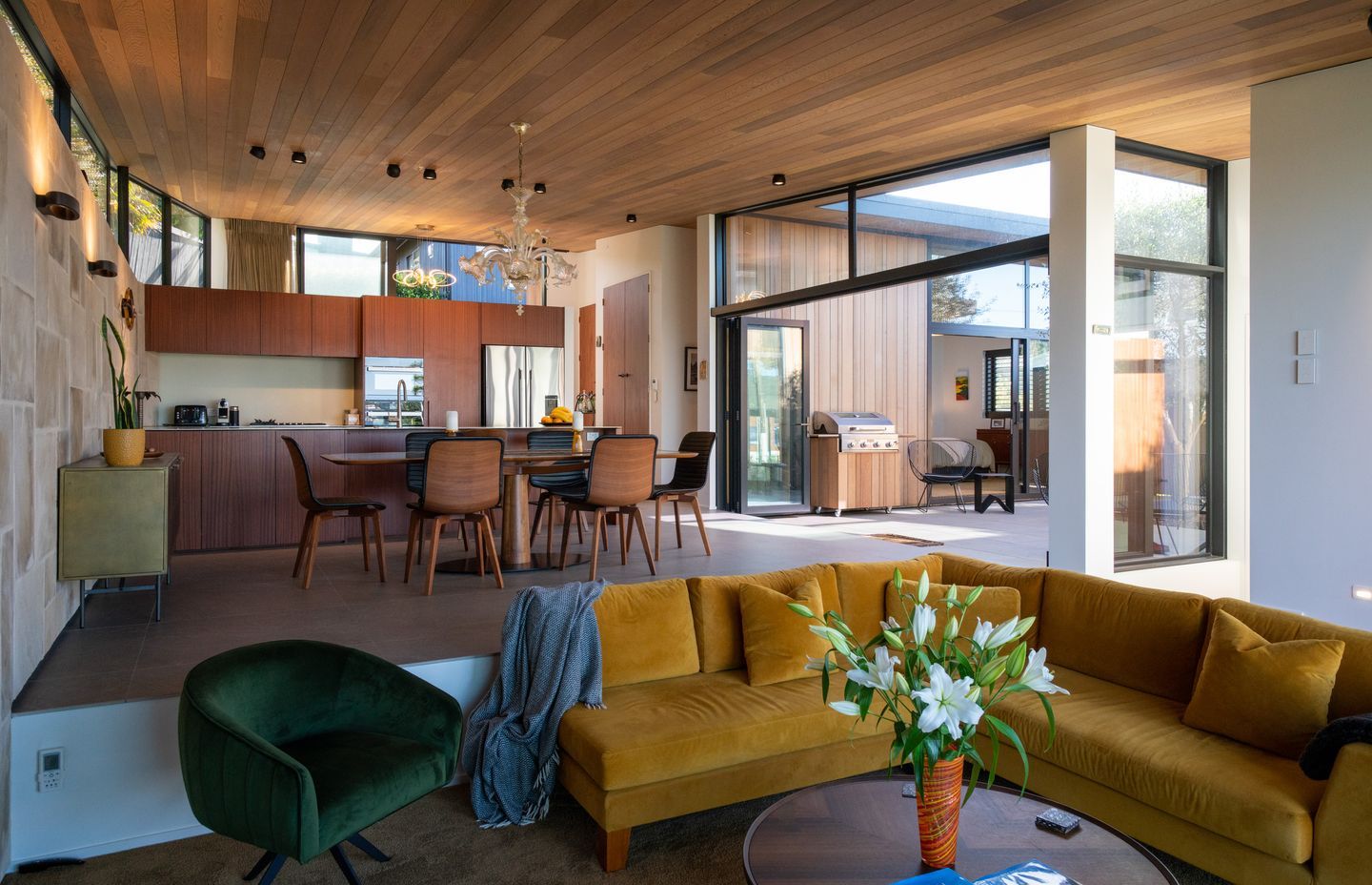 The lounge area steps down from the open-plan dining and kitchen space, ensuring the view can be enjoyed from both levels.