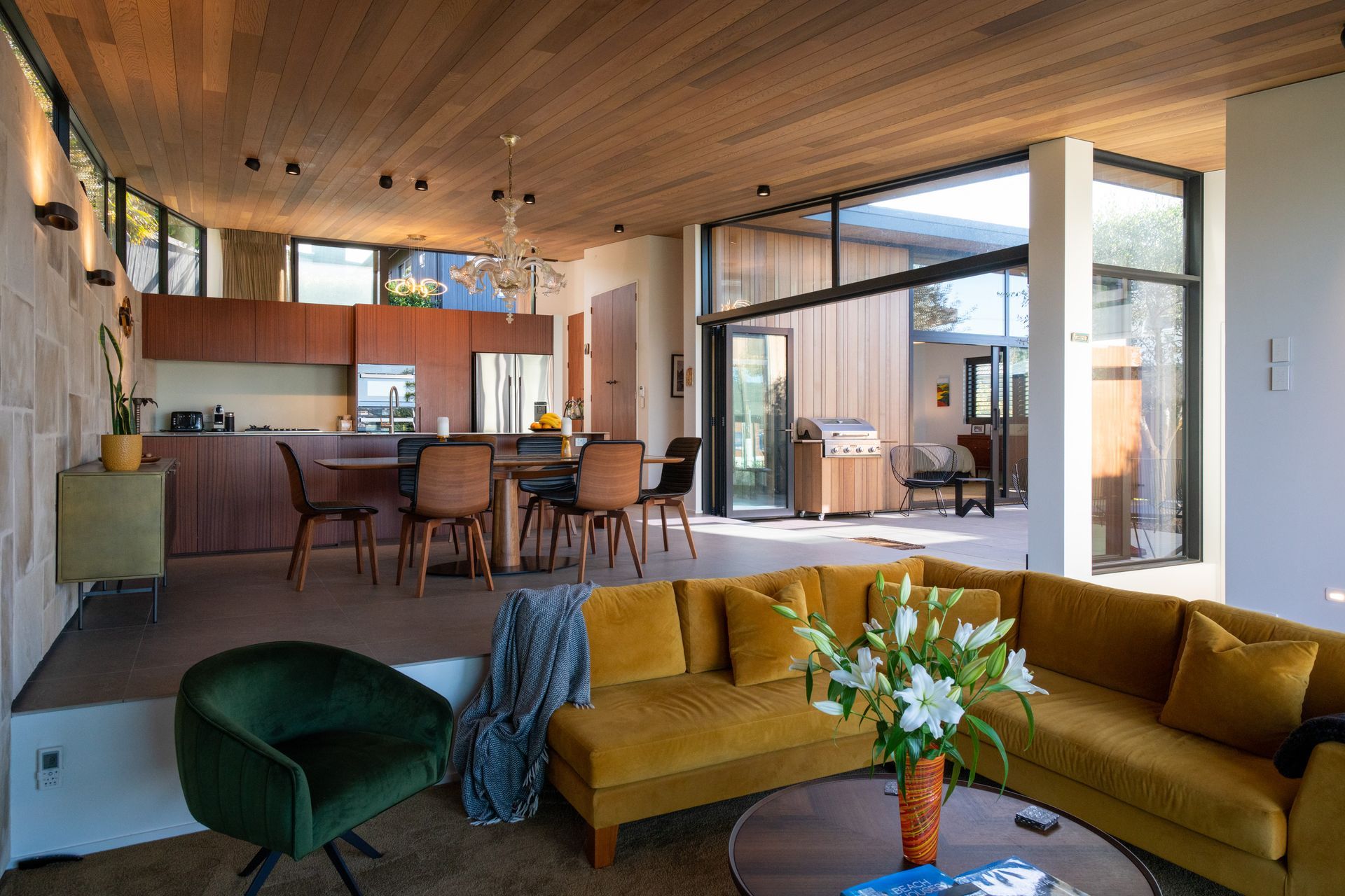 The lounge area steps down from the open-plan dining and kitchen space, ensuring the view can be enjoyed from both levels.