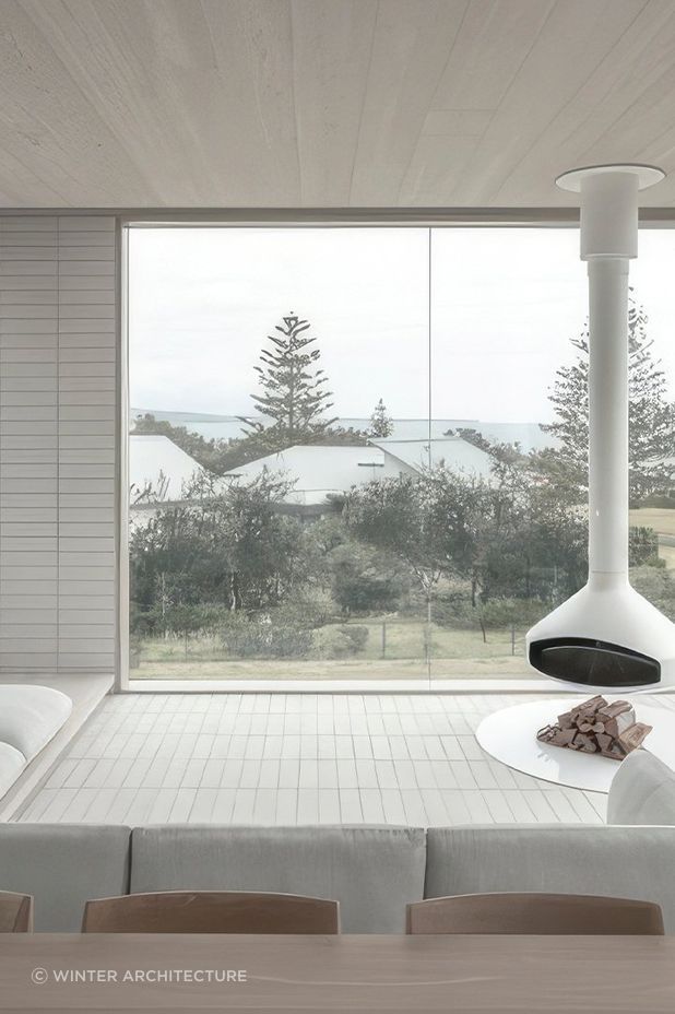 Interiors feature a carefully curated palette of white surfaces, soft sand, timbers and robust brickwork.