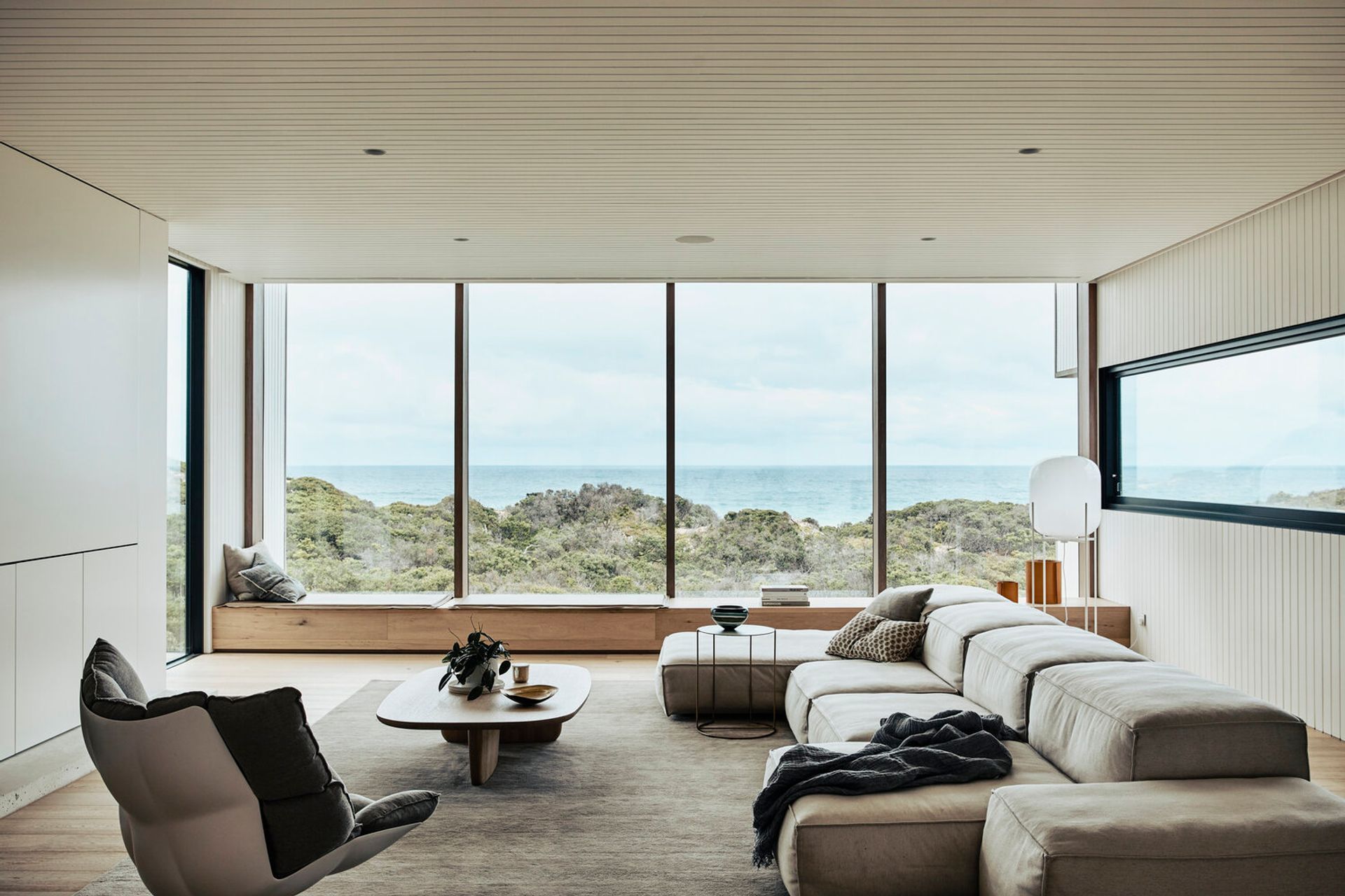 The stunning living room provides picturesque views of the surrounding sand dunes. Photography: Derek Swalwell.
