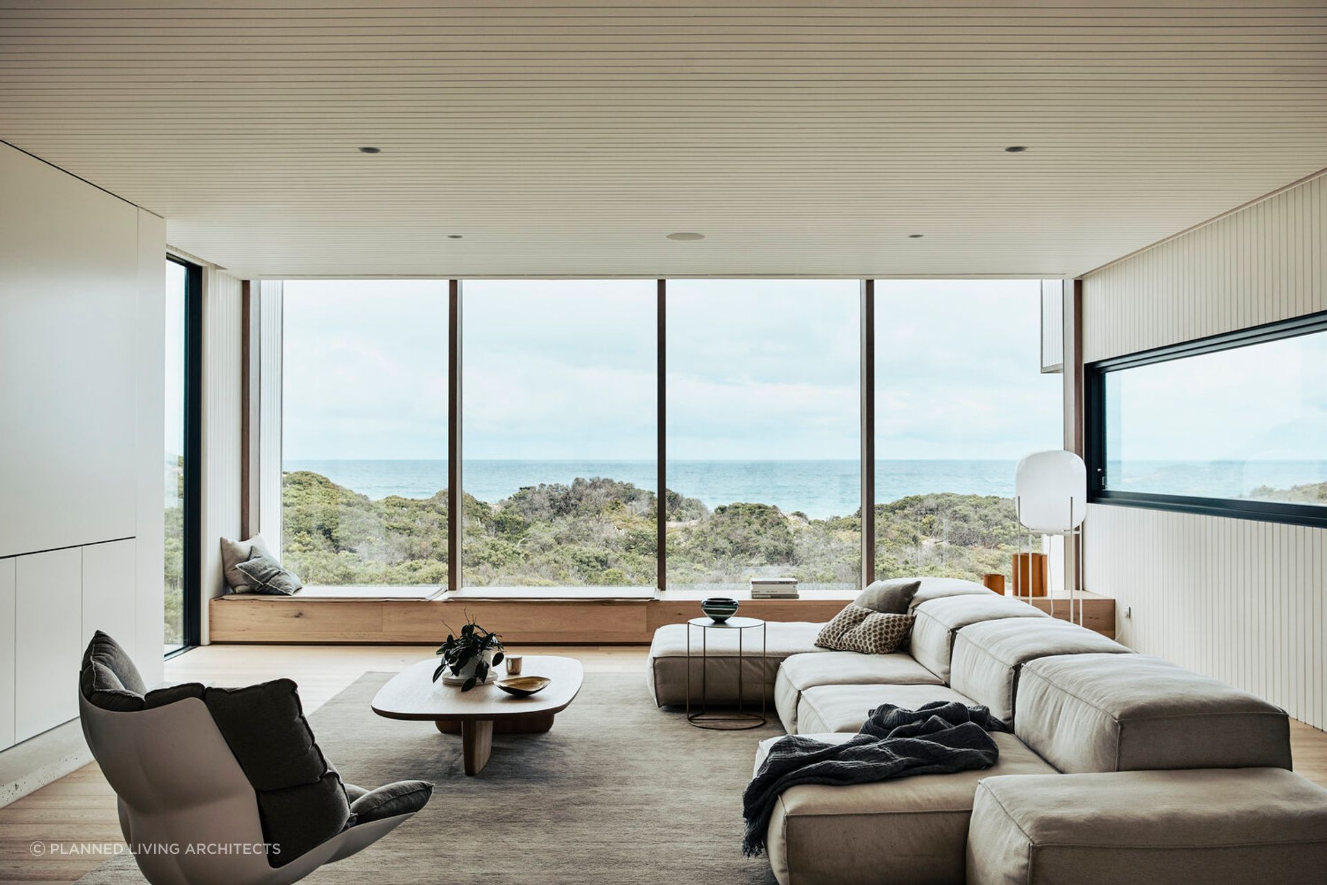 The stunning living room provides picturesque views of the surrounding sand dunes. Photography: Derek Swalwell.