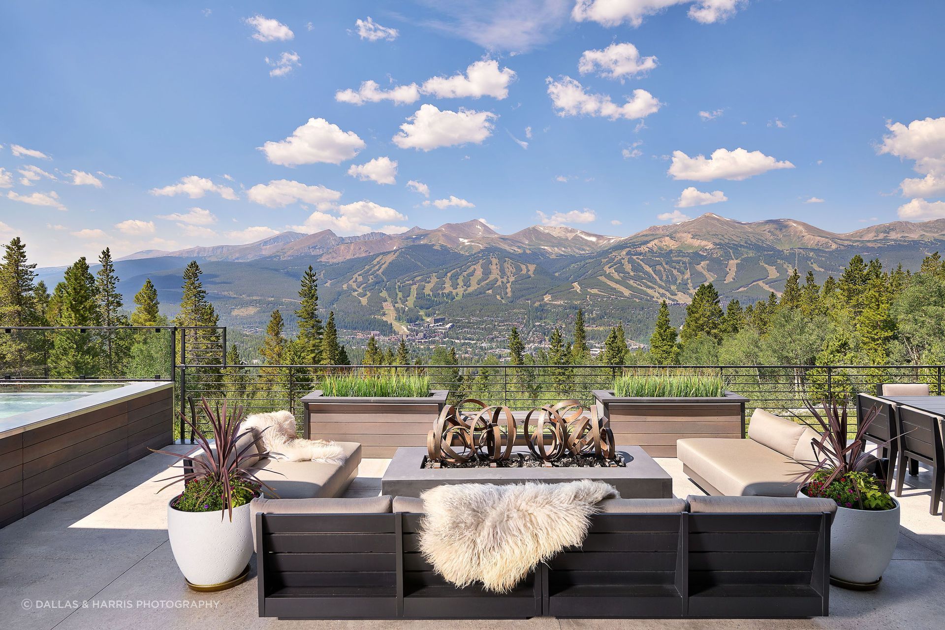 The occupied roof deck area located right off the living room at KA DesignWork's project holds multiple seating areas.