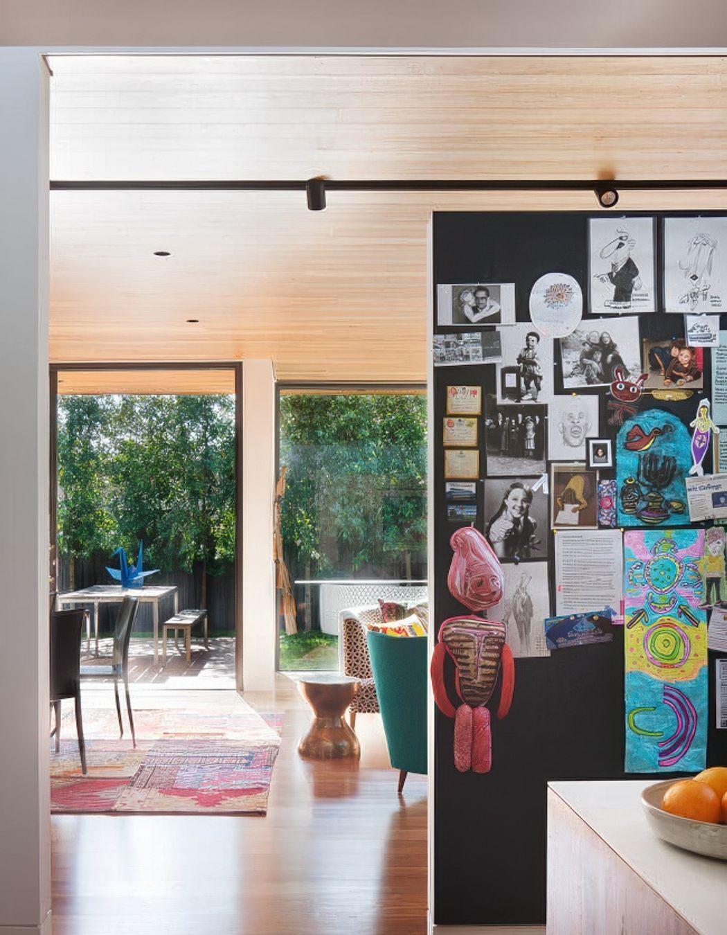 The big family pinboard at Kate's House kitchen keeps art and notices all contained in a fun display