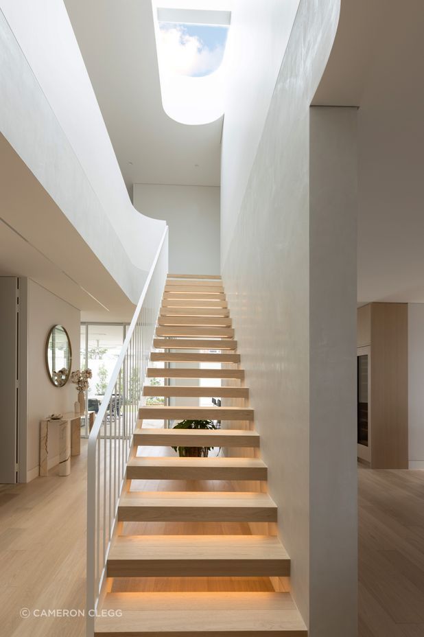 The Kogarah Bay project features stunning wood finishes and a statement central staircase.