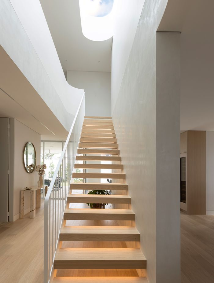 The Kogarah Bay project features stunning wood finishes and a statement central staircase.
