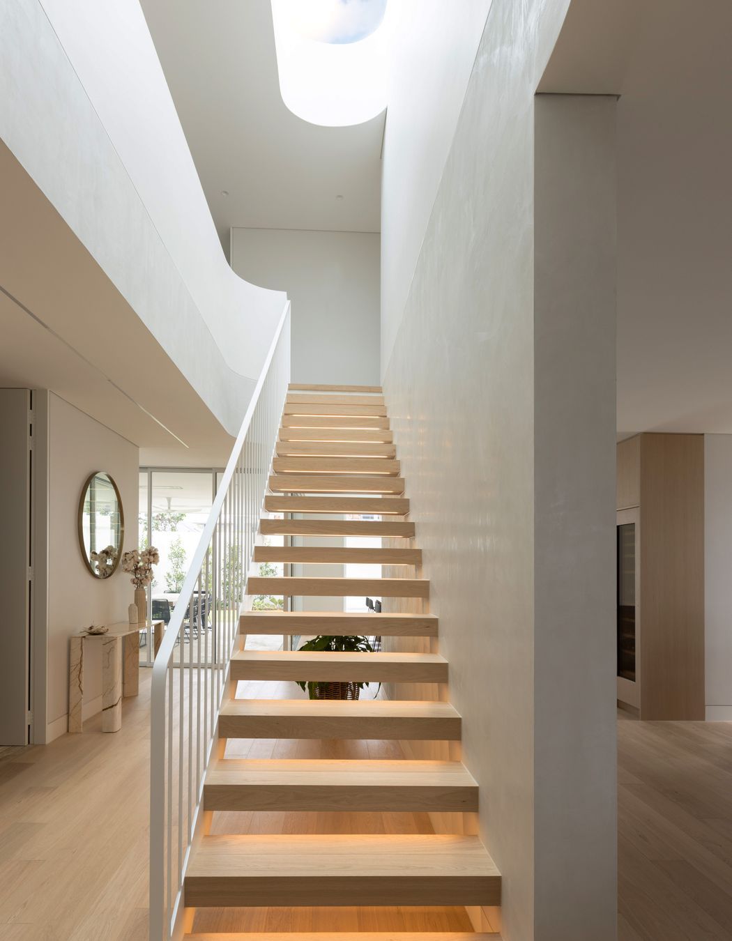 The Kogarah Bay project features stunning wood finishes and a statement central staircase.
