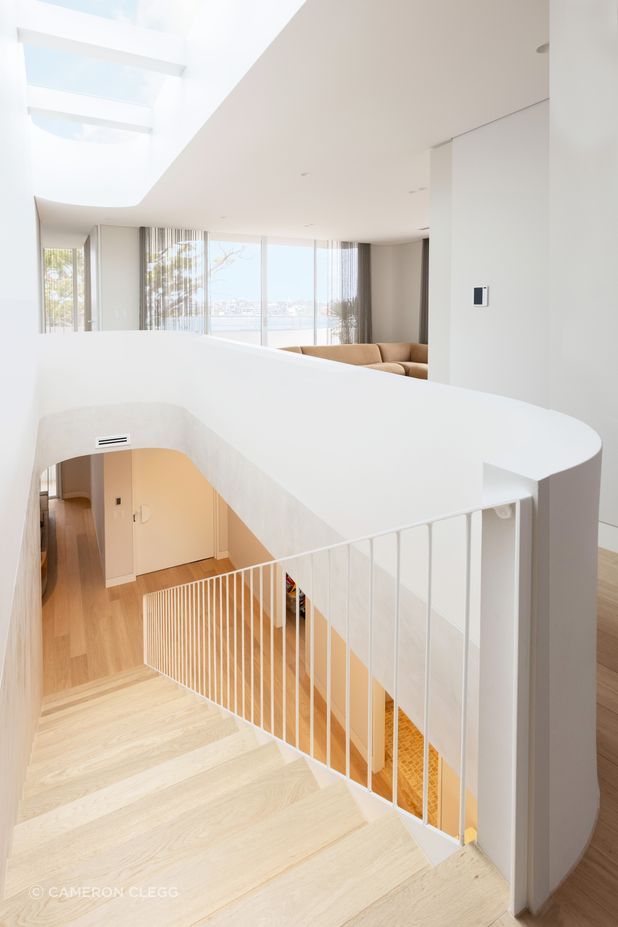 The curve wraps around upstairs to a second lounge area.