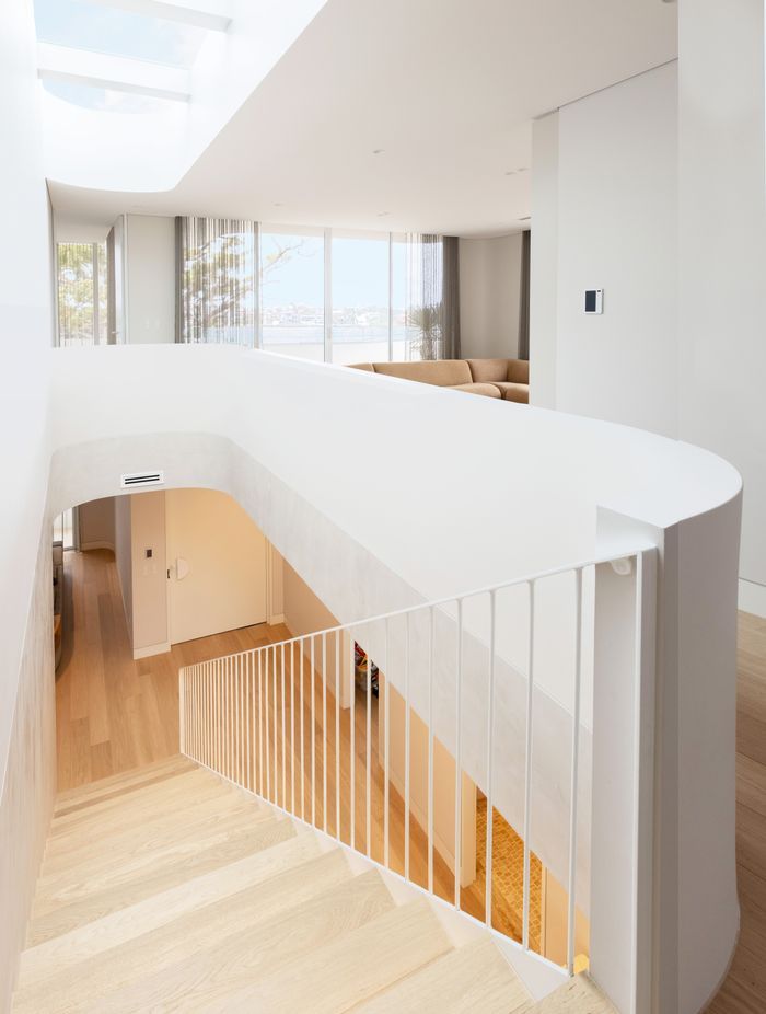 The curve wraps around upstairs to a second lounge area.