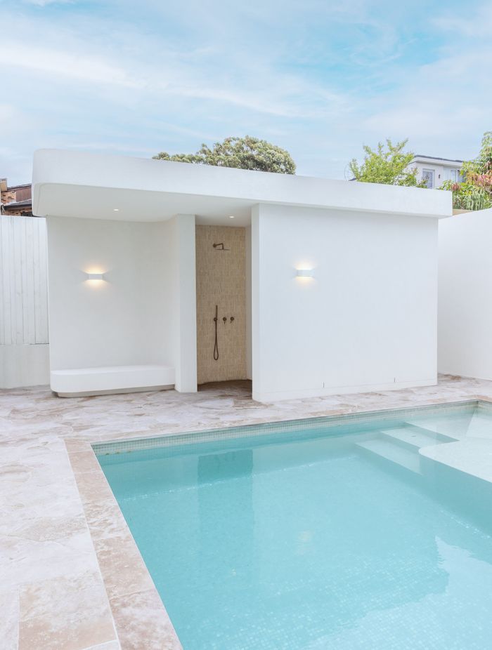 The home also features a stunning outdoor space, complete with a pool and bathroom/change area.