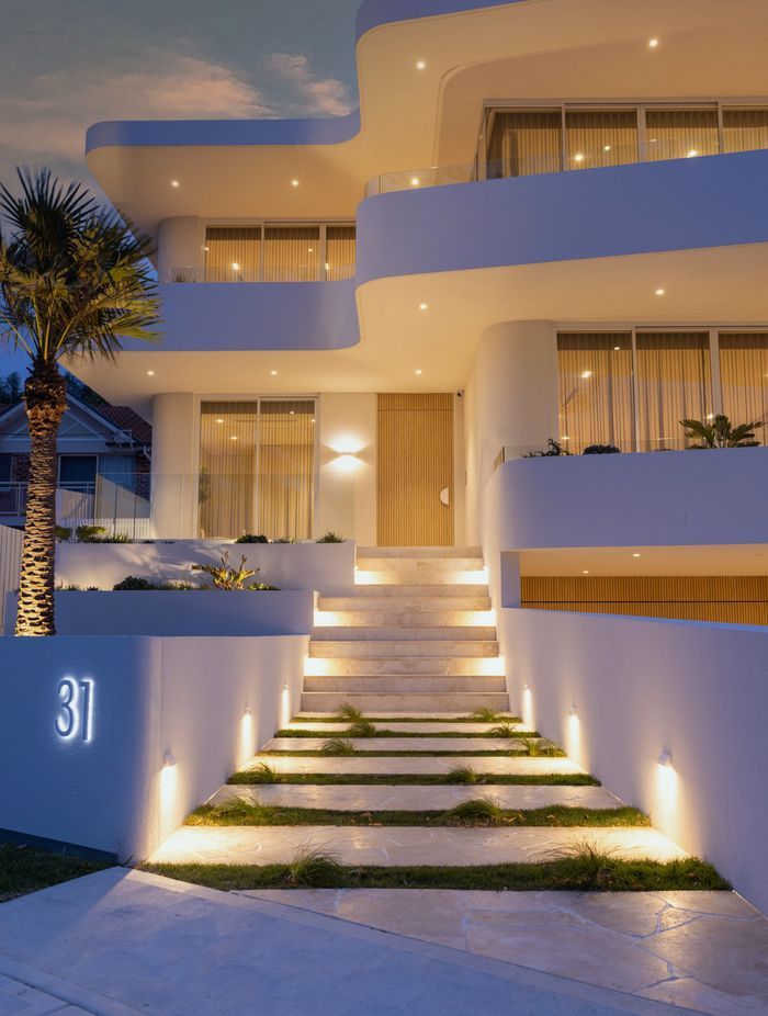 The modern curved facade sets the tone for a contemporary living space that effortlessly blurs the lines between indoors and outdoors.