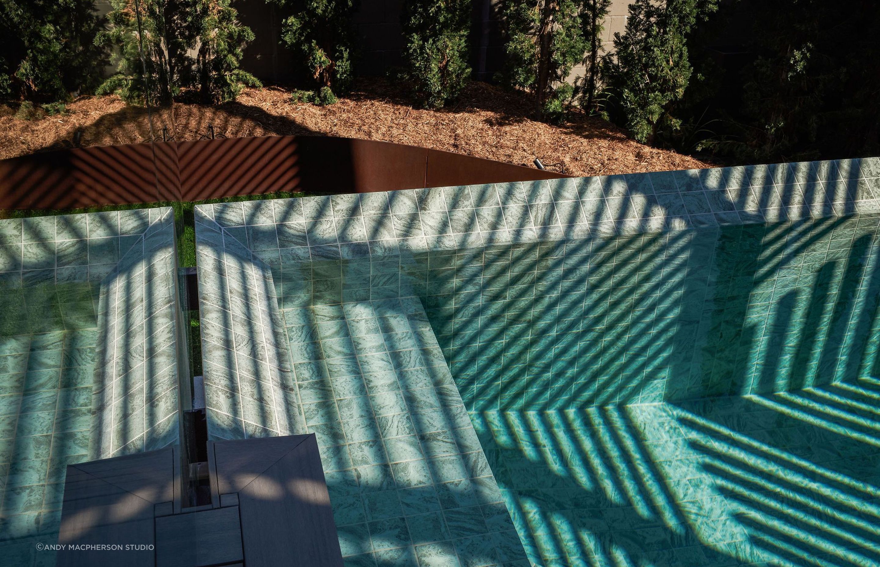 The palette extends to the exterior spaces, with rich textures and striking material choices.