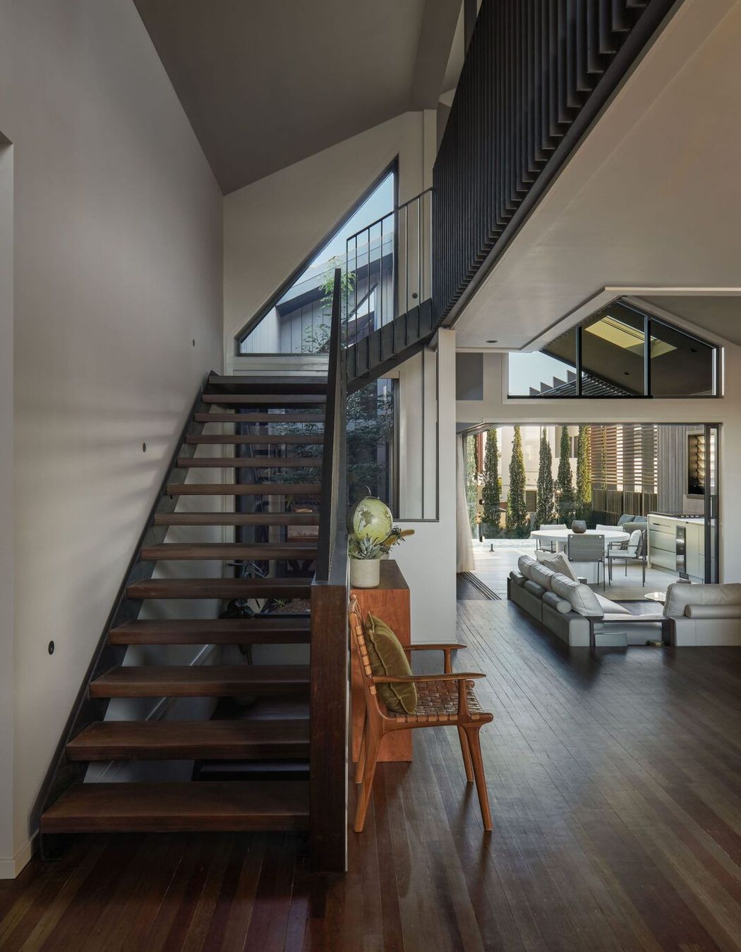 Vertical connectivity is achieved both visually and physically via the open riser stair and central atrium allowing an unobstructed line of sight between the living area and loft, making the space feel more expansive.