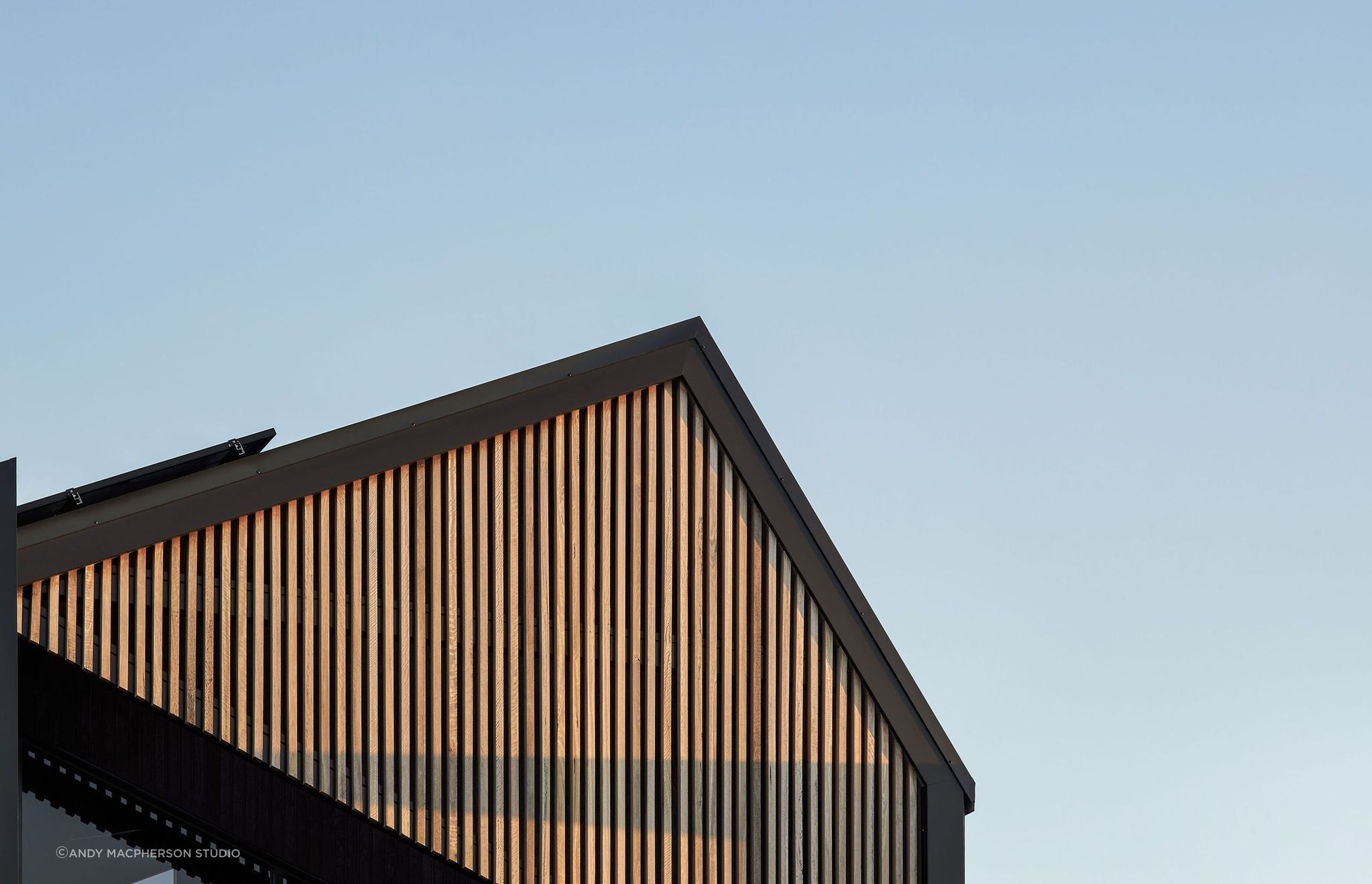 The facade, a canvas of rich hues and textures, tells a story that evolves with the sun's journey.