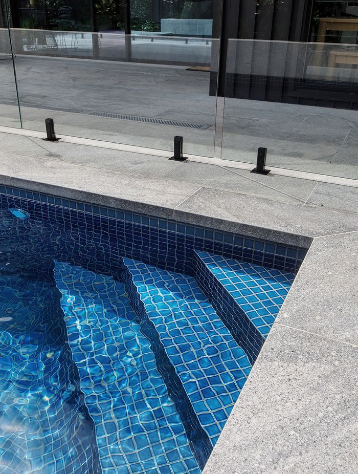The flamed finish on the granite poolside paving provides slip resistance.