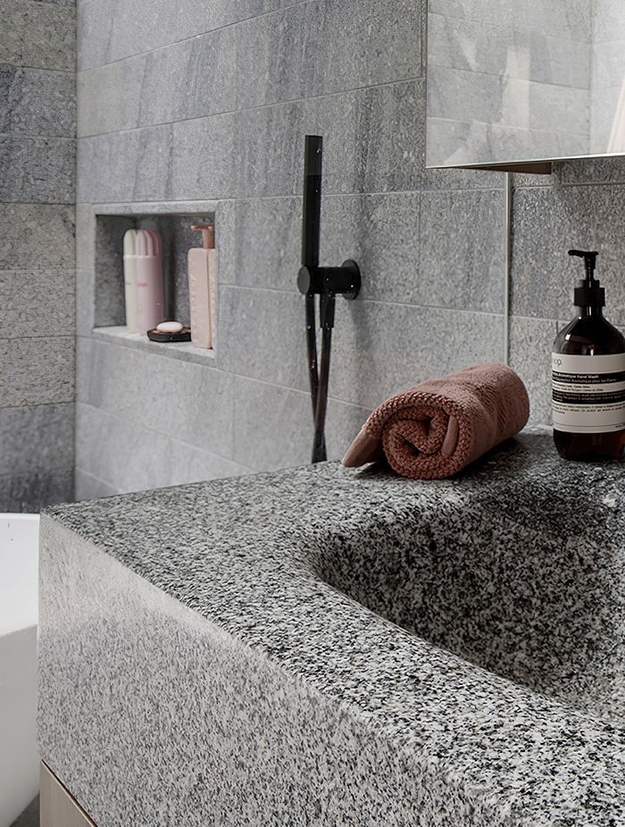 Aston grey granite is used extensively throughout the bathrooms.