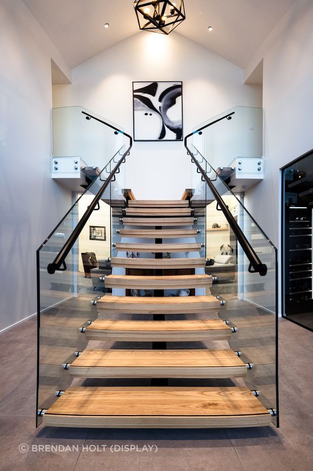 Floating timber stair treads add texture and warmth to the foyer area.